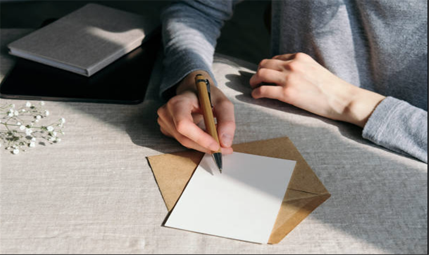 Image of a person starting to write a letter 