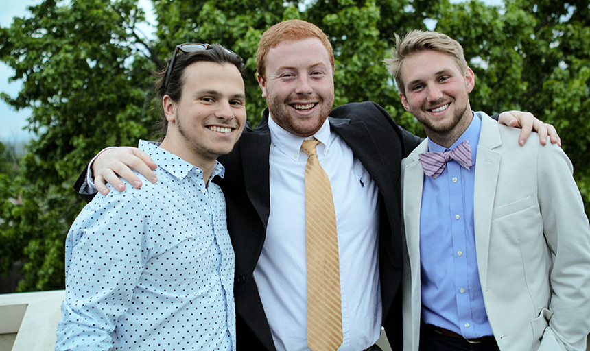 Three students dressed up in suits