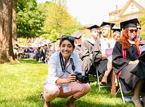 a student taking photos at commencement