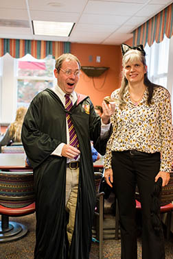 Chris Lassiter in a harry potter costume next to a colleague in a cat costume