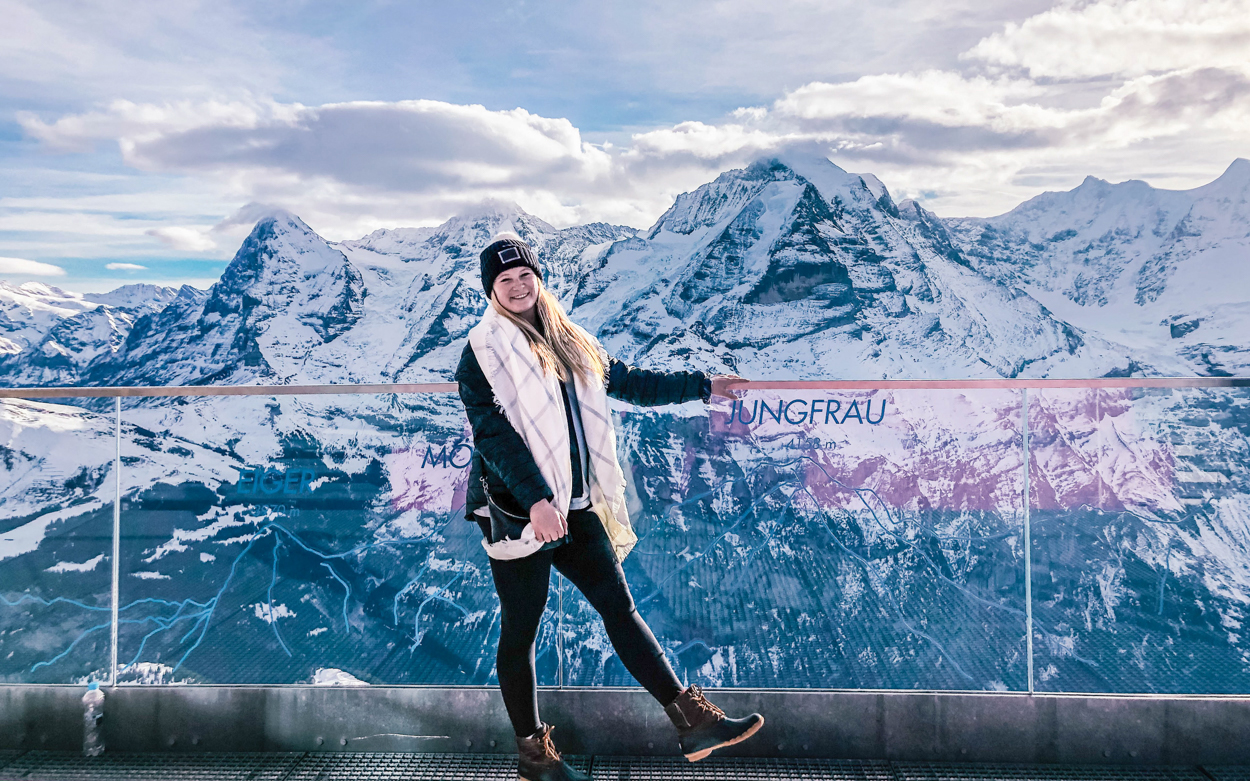 student standing in front of the mountains 