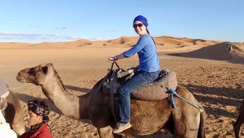 Student riding on a camel