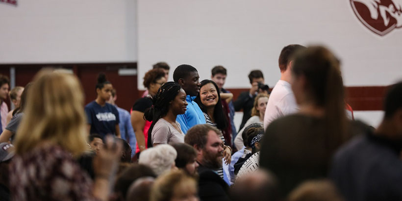 Audience members stand up.