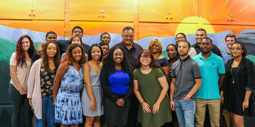 Students and staff pose for a photo with Jesse Jackson.