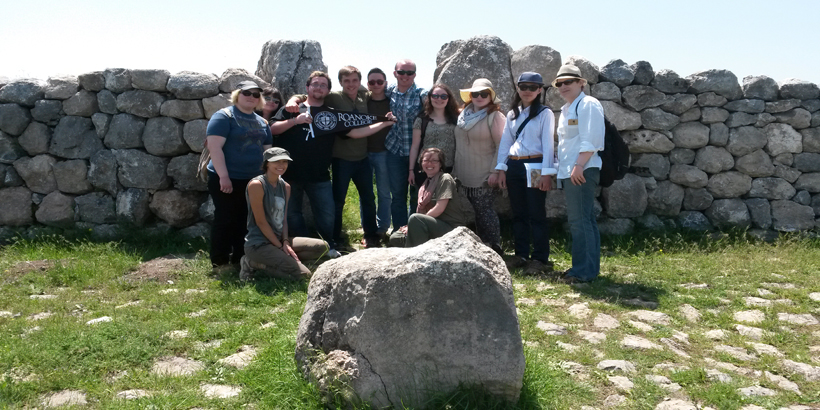 Roanoke students infront of a stone wall