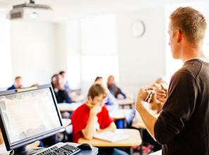 Students taking notes as a professor gives a lecture
