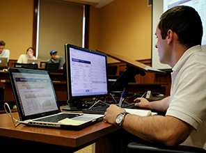 Student in accounting working on a computer