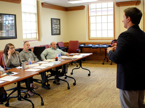 Student pitching an idea to a panel of professors