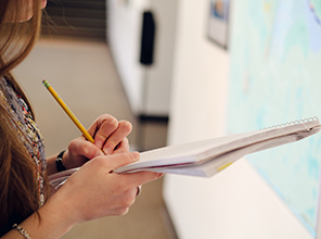 Student writing in a notebook