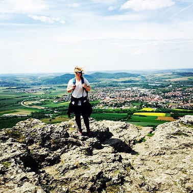 Student standing on a rocky ledge in Germany