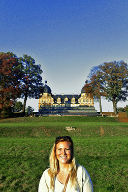 Photo of a student with a large building in the background