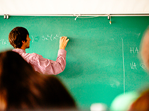 Professor writing on the chalkboard