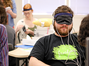 Student wearing an eyemask that records data