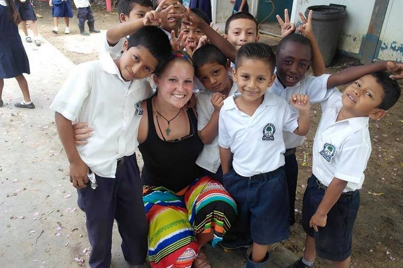 Student with children in Belize
