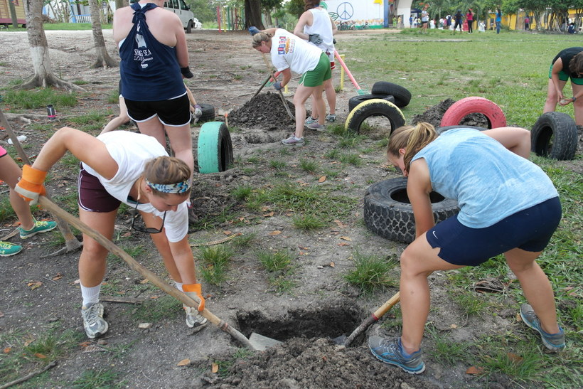 Students digging holes for tires