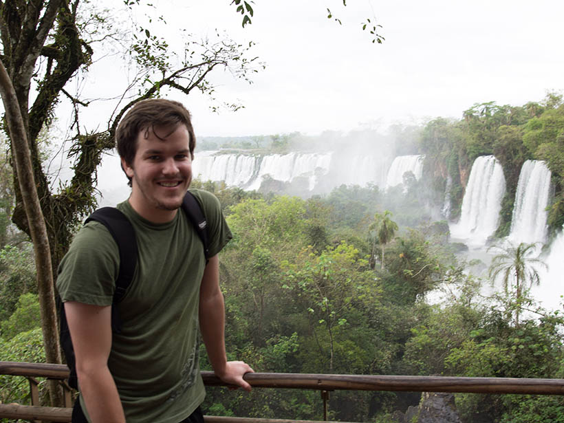 A student standing overlooking a waterfall