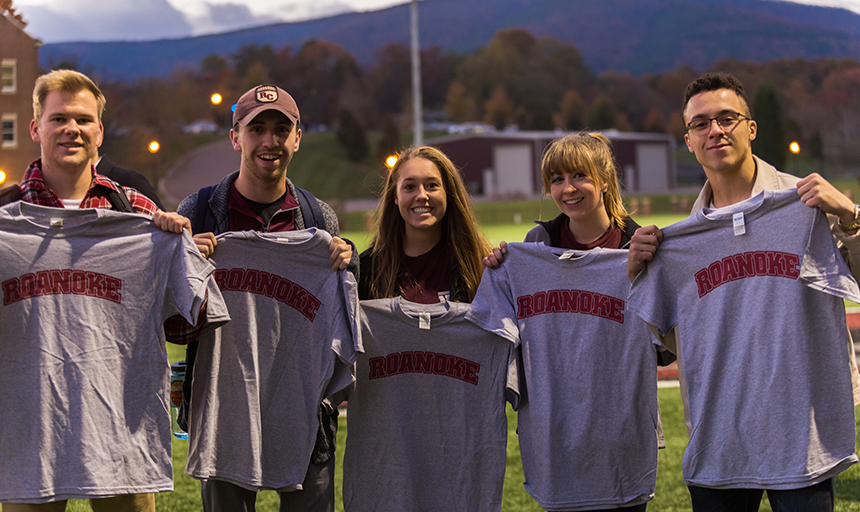 Students holding up their free "Roanoke" shirts