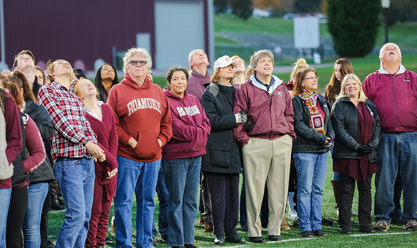 Faculty and staff looking up at the drone on Kerr Stadium