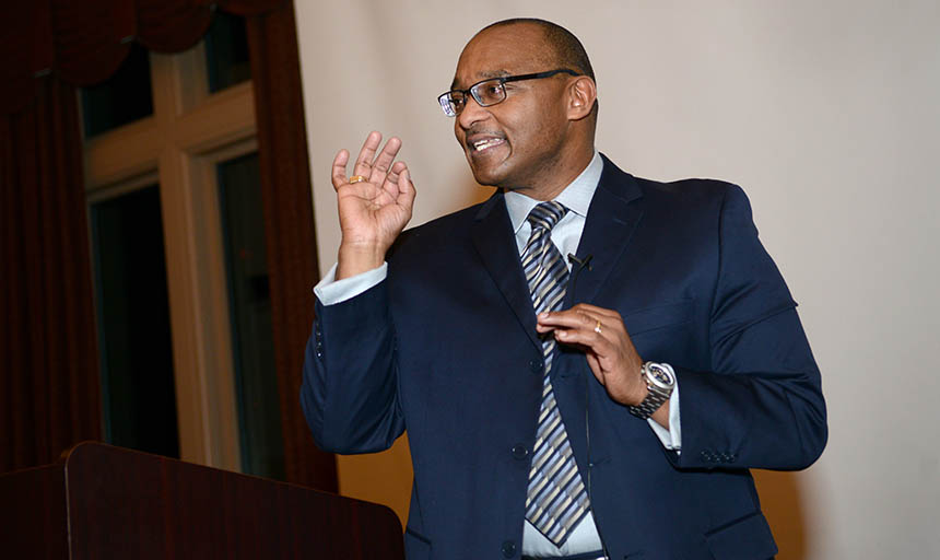 Dr. Braxton giving a speech at a podium