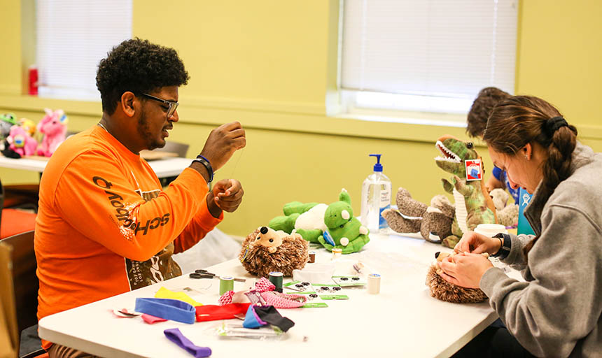 Roanoke College students modifying toys for the Toy Like Me club