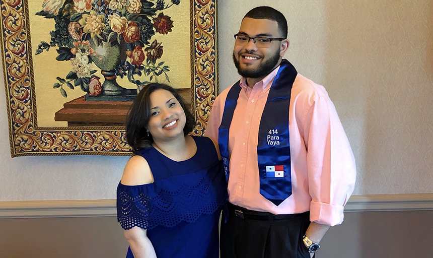 Brother and sister smiling together at graduation event