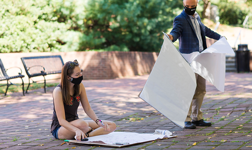 Student and professor participating in class outdoors