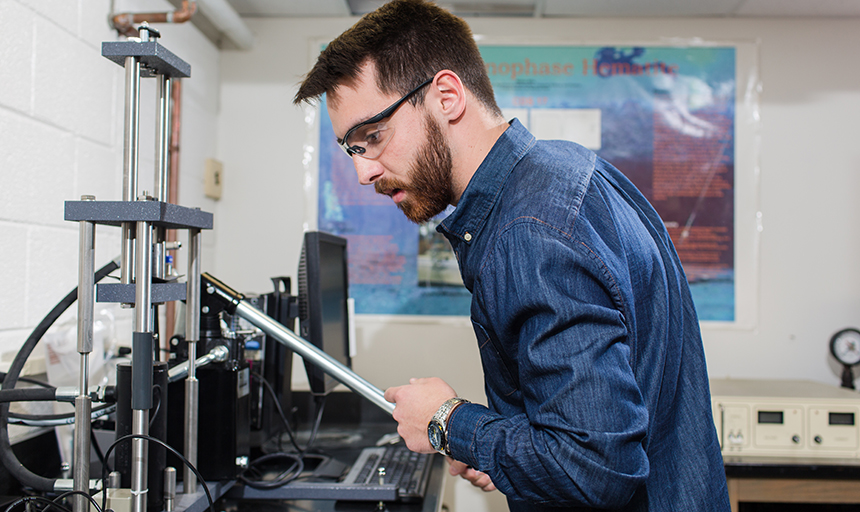 Student in lab working on equipment