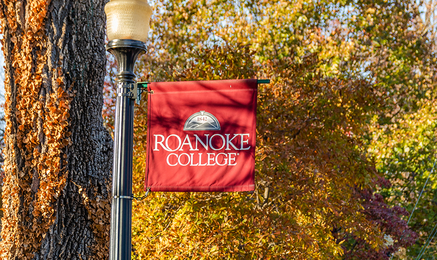 Roanoke College flag with fall leaves