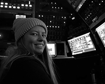 Rachael Storo in submarine in front of computer monitors