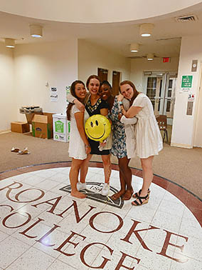 Students posing for a group photo at their mock commencement