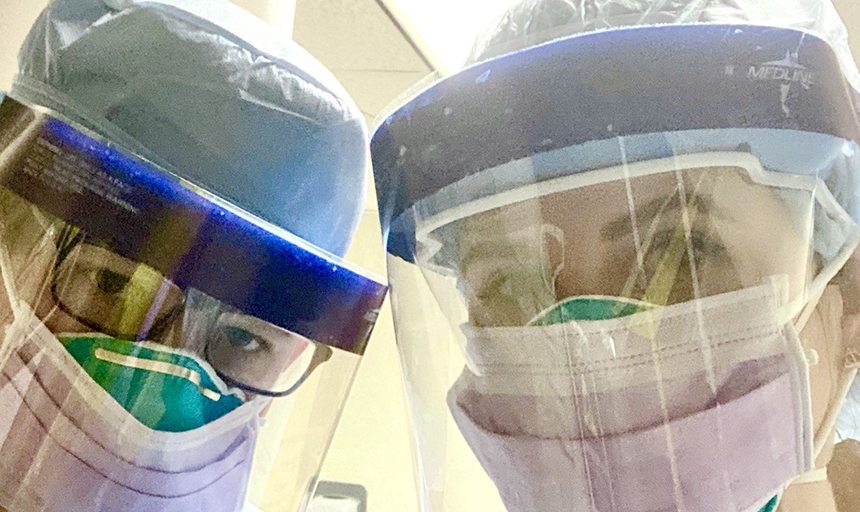 Two doctors wearing face shields