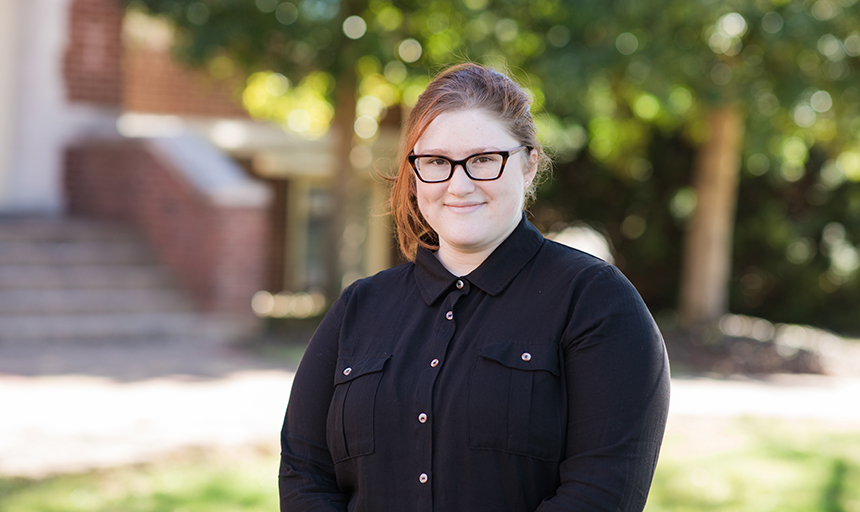 Student smiling outdoors on campus