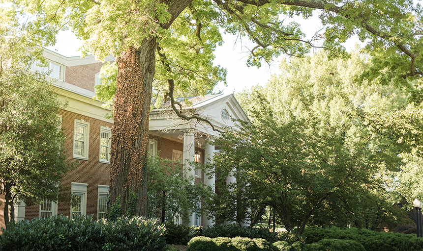 lush greenery in front of campus building