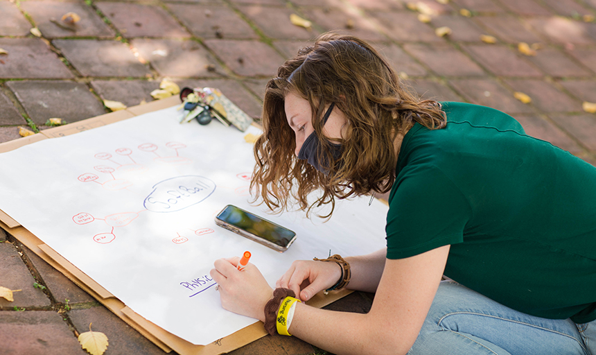 Student takes notes during outdoor class