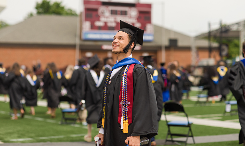 graduate smiling in cap and gown