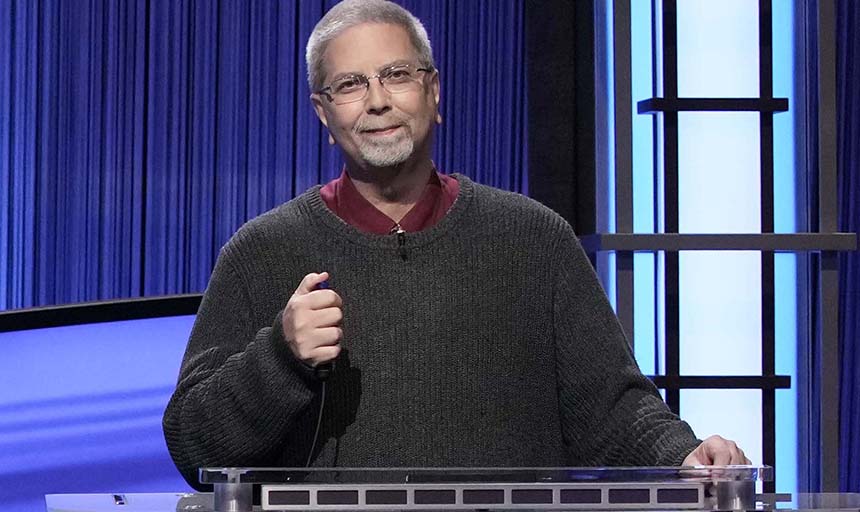 Gary Hollis pictured on Jeopardy set holding the buzzer