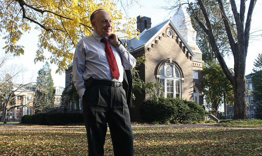 Man standing on college campus smiling