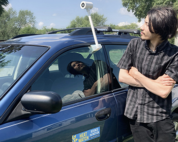 Volunteer looks at heat sensor on car