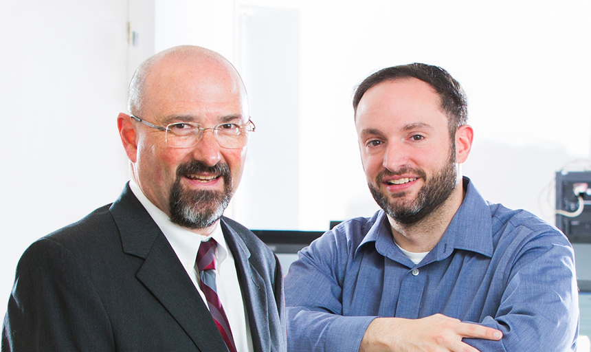 two men smiling in bright light