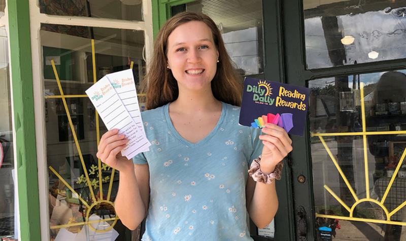 Katherine Vaughan holds up the bookmark she designed for Dilly Dally's Reading Rewards promotion