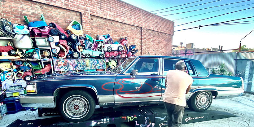 Kenny Scharf spray paints art on to car