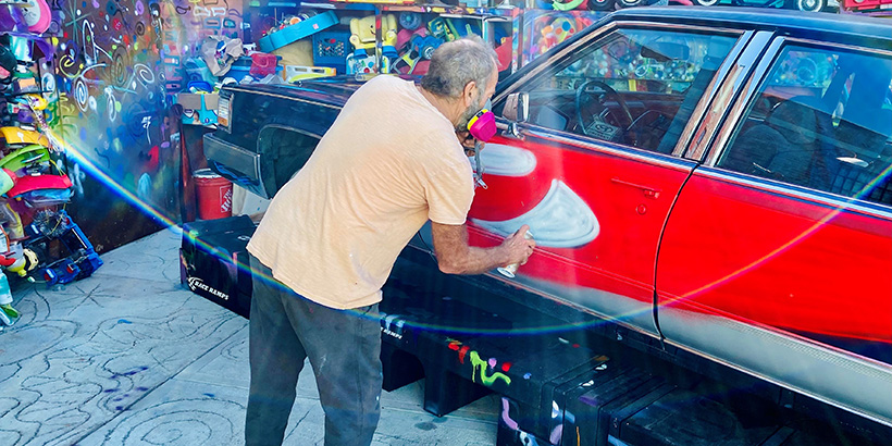 Kenny Scharf spray paints art on to car