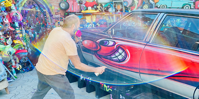 Kenny Scharf spray paints art on to car