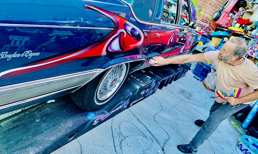 Karbombz artist Kenny Scharf paints Norma the art car