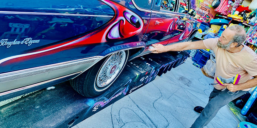 Kenny Scharf spray paints art on to car