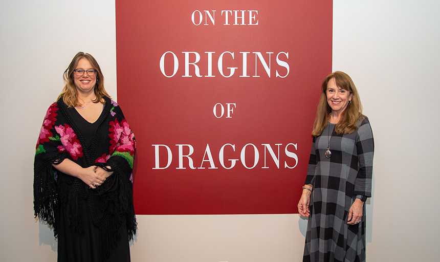 Two professors in front of sign that says "The Origin of Dragons"
