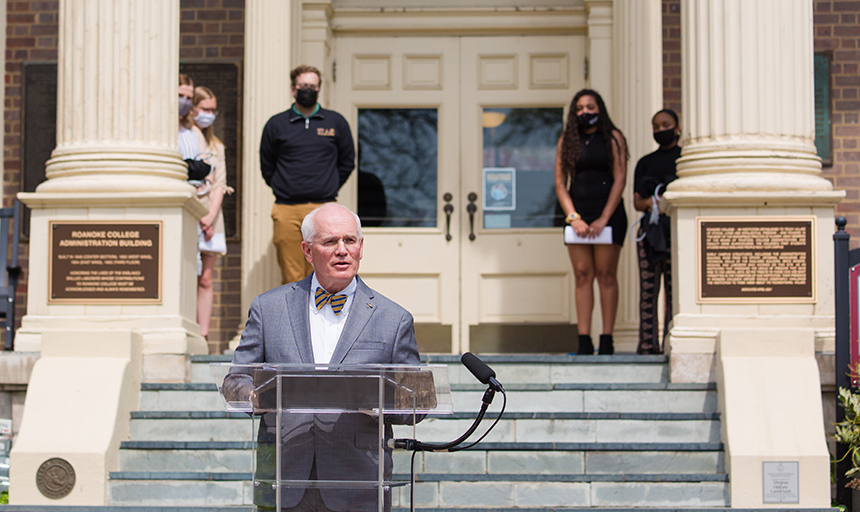 President Maxey and students on Administration Building steps, two plaques on columns