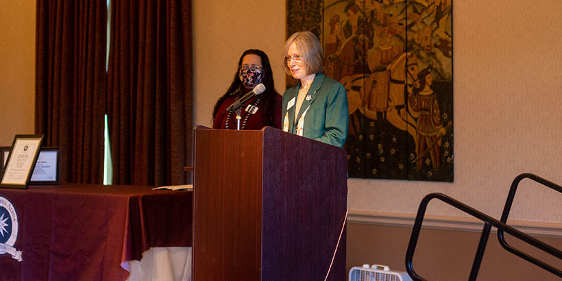 Faculty giving a speech at the ceremony