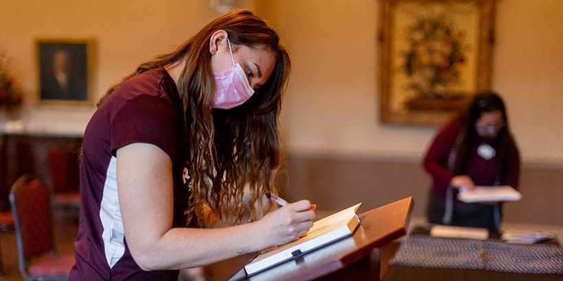 A student signing her name