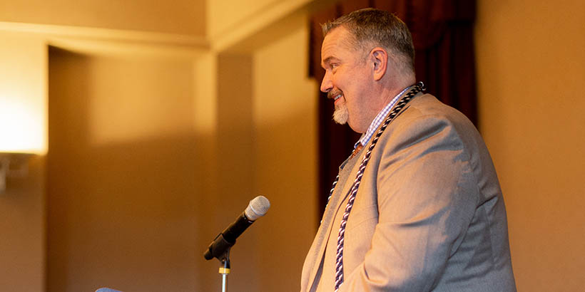 A faculty member speaking at the ceremony